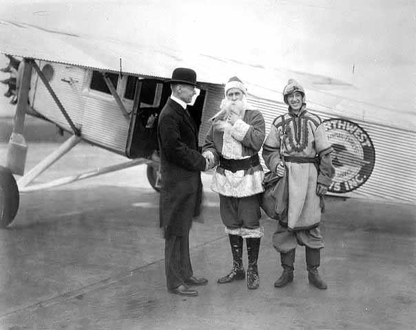 Black and white photograph of Santa Claus arriving via Northwest Airlines for a stay at L.S. Donaldson Company during the Christmas season, 1930.