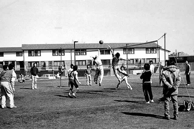 Hmong young people playing volleyball on the playground at Western and I-94, St. Paul, ca. 1980s. Photo by Michael Kieger.