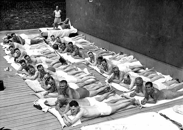 Black and white photograph of sun bathers on the sun deck of the St. Paul Athletic Club, c.1935.