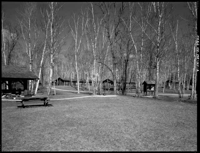 Southwest section of Civilian Conservation Corps Camp Rabideau F-50, looking northeast, with (left to right) picnic shelter, barracks, forest service officer’s quarters, and hospital. Photo by Jerry Mathiason, 1994. From box 1 (144.G.8.4F) of Historic American Buildings Survey records related to Minnesota structures, 1882-2001, 1883. Manuscripts Collection, Minnesota Historical Society, St. Paul.