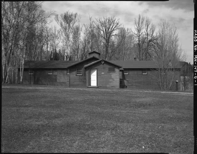 Exterior view of the mess hall (Building 8), CCC Camp Rabideau F-50. Photo by Jerry Mathiason, 1994. From box 1 (144.G.8.4F) of Historic American Buildings Survey records related to Minnesota structures, 1882-2001, 1883. Manuscripts Collection, Minnesota Historical Society, St. Paul.