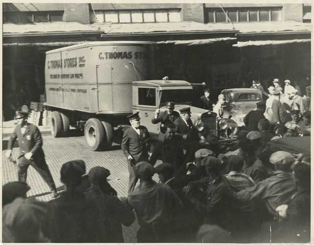 Black and white photograph of police and strikers, 1934.