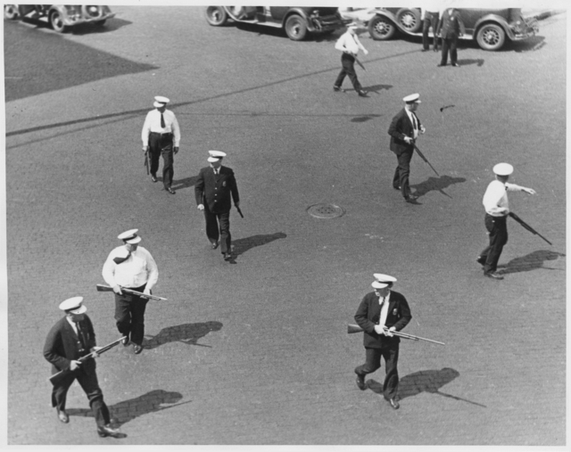 Black and white photograph of police carrying shotguns during the truck drivers’ strike, 1934.