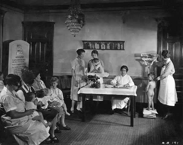 Black and white photograph of children being weighed at the Emanuel Cohen Center Clinic in Minneapolis c.1925.