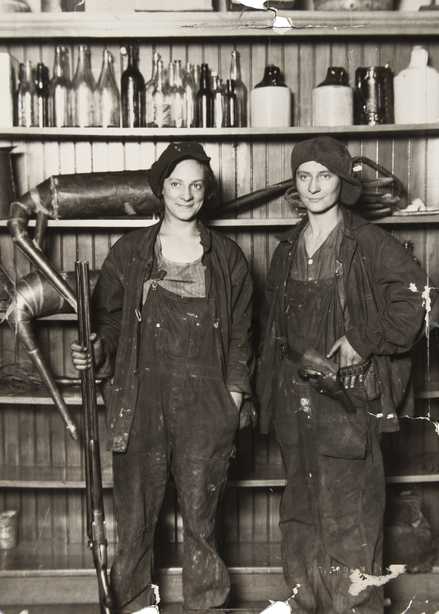 Black and white photograph of two women arrested by federal agents for making moonshine near St. Paul, 1921. Photographed by the St. Paul Daily News.