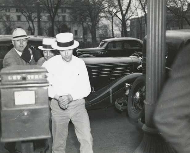 Black and white photograph of Alvin Karpis captured by federal agents and brought to St. Paul in connection with the Hamm and Bremer kidnappings, 1936.