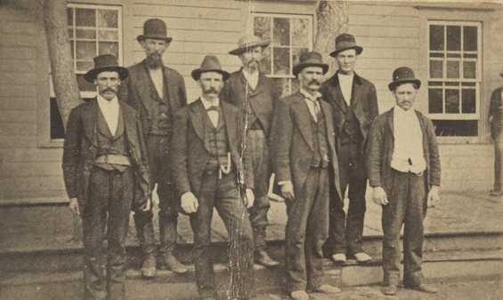 Black and white photograph of the six officials and volunteers, known as the “Madelia Seven,” who captured the Younger brothers outside Madelia on September 21, 1876.