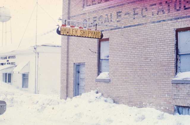 Color image of the Hawley Shipyard sign on the old warehouse that was used to build and store the Hjemkomst. From the Tom Asp Collection, Historical and Cultural Society of Clay County.