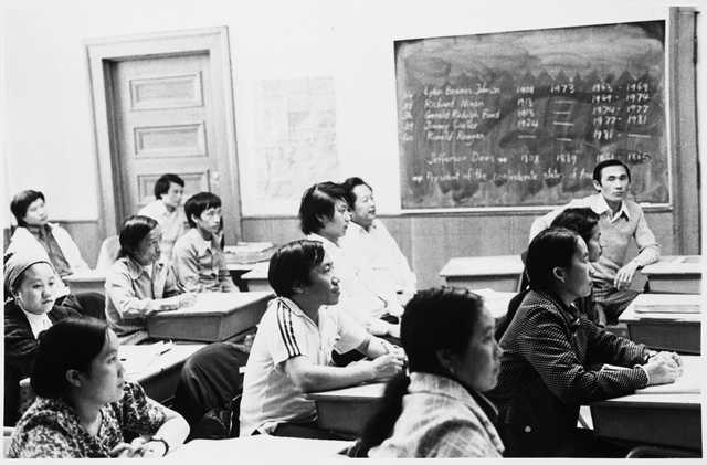 Black and white photograph of Hmong students in a class at the Lao Family Community Center inside a branch of the St. Paul YMCA, c.1980. 