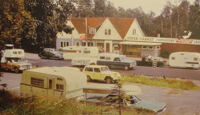 Color image of Lamb’s Resort, ca. 1968, after Skip and Linda Lamb purchased it; a new laundry and grocery addition is at the right of the inn.
