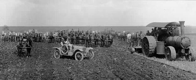 Black and white photograph of men, horses, farm implements in field, Northcote farm, Northcote, Minnesota, 1914. Photograph by William Hartvig.