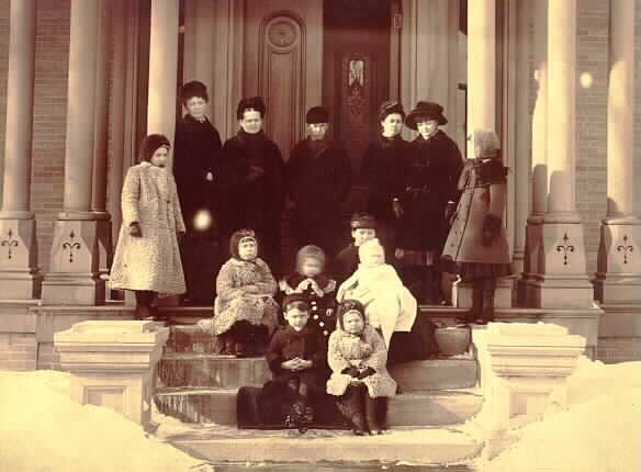 Black and white photograph of Mary Mehegan Hill, Grace Upham, and several of their children at the Uphams’ Lowertown St. Paul home, c.1883.