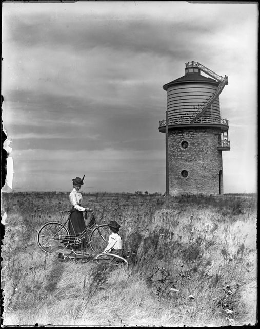 Two women with bicycles near Mni Owe Sni (Coldwater Spring)