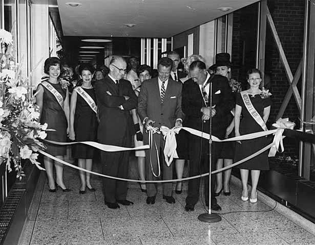 Black and white photograph of he opening of the first Minneapolis skyway, connecting the Northstar Center and the Northwestern National Bank; Leslie Park is at left, 1962.