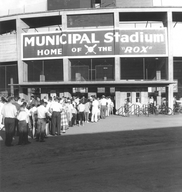 Photograph of Municipal Stadium, the home of the St. Cloud Rox from 1948-1970, showing the exterior of the stadium and a line of people waiting to get into the game, c.1950. From the Myron Hall Collection, Stearns History Museum and Research Center, St. Cloud.