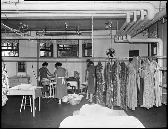 Incarcerated women working in laundry room