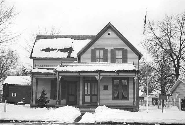 Black and white photograph of Sinclair Lewis’ childhood home, December 1975. Photographed by Henry Harren.