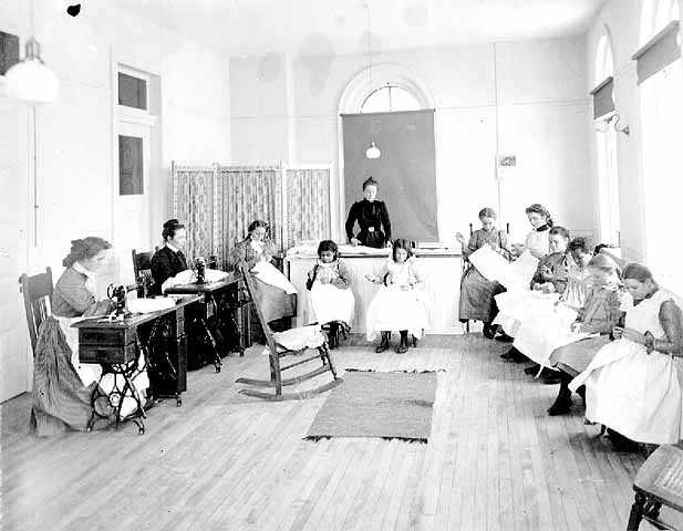 Black and white photograph of sewing class at the State School, c.1905.