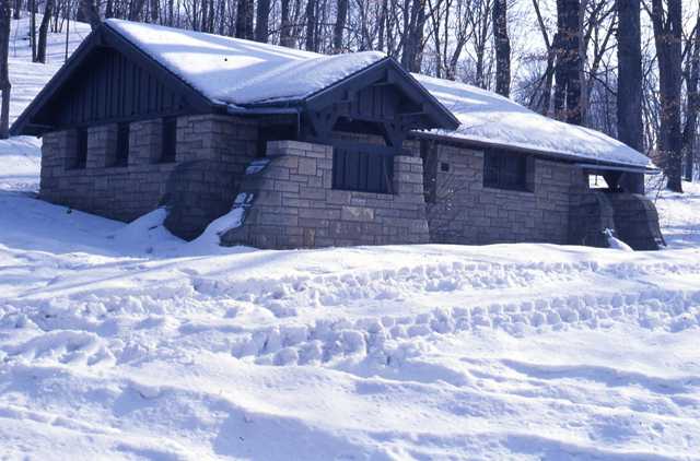 Color image of the rustic-style latrine built in 1939 by the WPA. Architect: H. Petersen.
