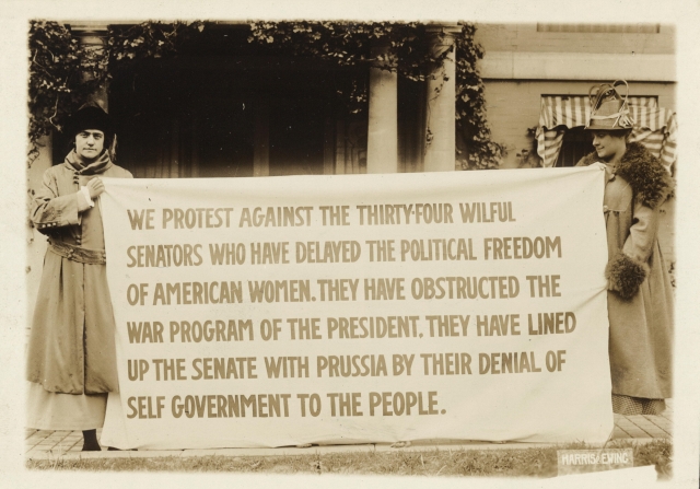 Bertha Moller holding a banner