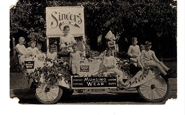 photograph of children on a parade float wearing Munsingwear long underwear.