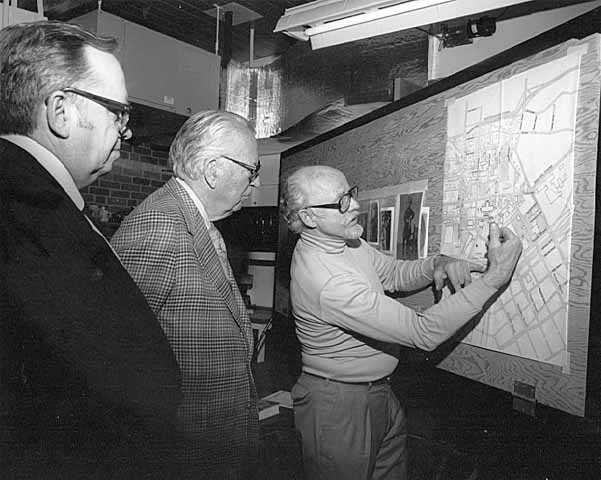 Paul Granlund looking at a map of St. Paul with Russell Fridley and Elmer L. Andersen