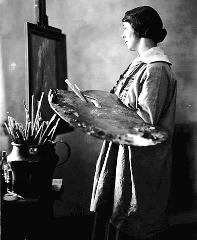 Black and white photograph of Elsa L. Jemne working at an easel, 1922.