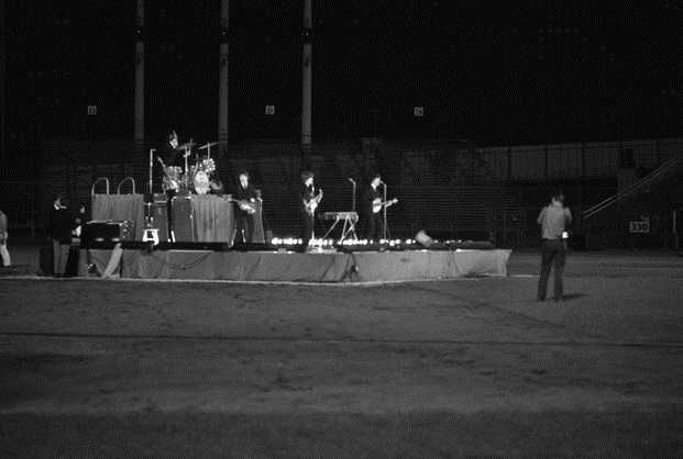 Black and white photograph of The Beatles in concert at Metropolitan Stadium, Bloomington, August 21, 1965. Photograph: Neale, St. Paul Dispatch & Pioneer Press.
