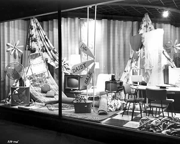 Black and white photograph of Daisy sale window display, Dayton’s, 1956. 