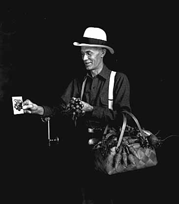 Man with vegetables grown from Northrup, King seeds