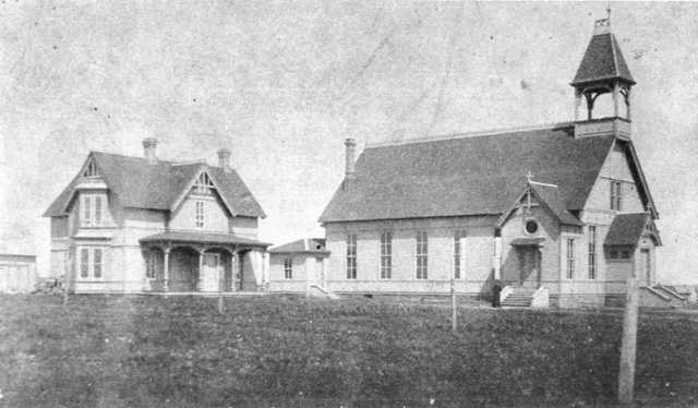 Black and white photograph of the exterior of the Immaculate Heart of Mary Catholic Church in Currie, ca. 1883.