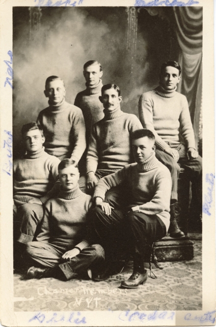 Black and white photograph of seven charter members of a secret society known as "The Greys," 1910. The group became the Nu Upsilon Gamma fraternity in 1920, disbanded in the 1990s and reactivated in 2001.