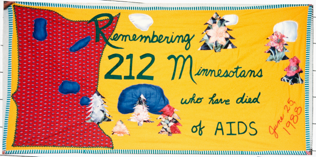 Color image of a quilt panel memorializing 212 Minnesotans who had died of AIDS, 1988.
