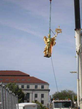Color image of the figure of "Prosperity" being removed for restoration, September 23, 2014. Photographed by Linda A. Cameron.