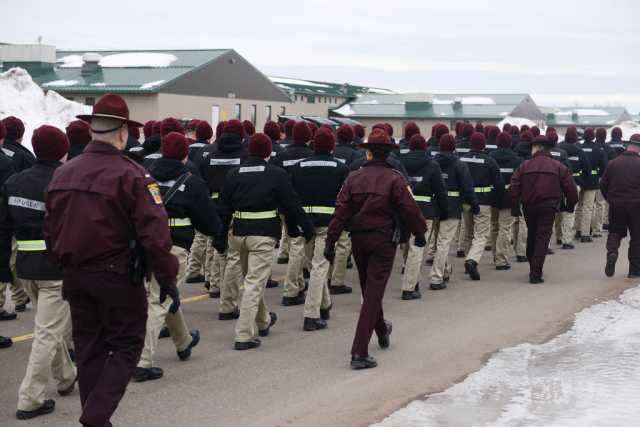Color image of cadre and candidates of the Minnesota State Patrol’s Trooper Academy march between classes at Camp Ripley, February 2016.