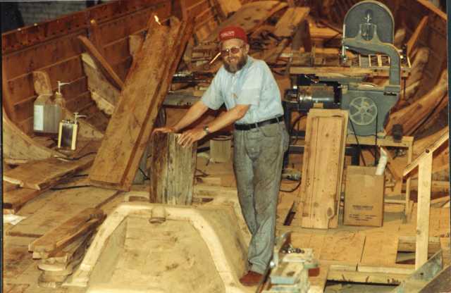Color image of Robert Asp working on board the Hjemkomst. Photograph by Rose Asp, ca. 1980. From the Rose Asp Collection, Historical and Cultural Society of Clay County.