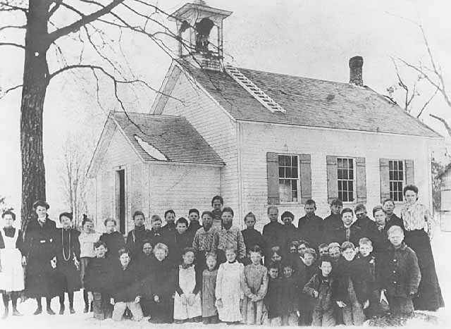 Rural one-room schoolhouse, students, and teacher, ca. 1910. Photograph by John Runk.