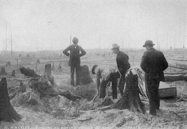 A search party finds the remains of an entire family in the ruins of the Hinckley fire, 1894.