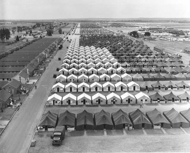 Black and white photograph of tents and "hutments" at Camp Ripley, 1965.