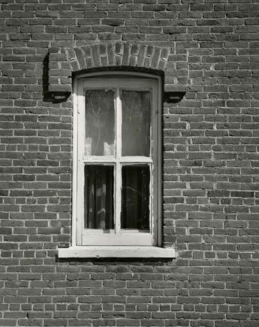 Black and white photograph of a window in the Arnold Nietfield house in Meire Grove.