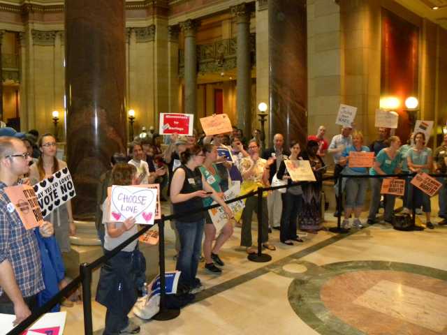 Color image of demonstrators gathered at the State Capitol in St. Paul to show their opposition to Minnesota Amendment 1. Photographed on May 20, 2011, by Flickr user Flickr user Fibonacci Blue.