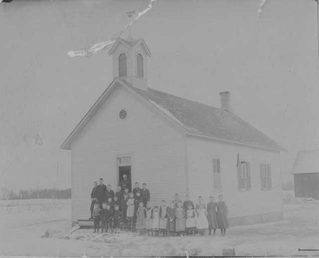 Photograph of Mayer public school (District #73) c.1895. Teacher Thomas Burns stands with his students outside the one-room schoolhouse. Photograph Collection, Carver County Historical Society, Waconia.