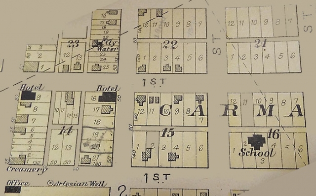 Photograph of page in Polk County plat book (1902) showing locations of Carman’s creamery, hotels, school, and artesian wells.