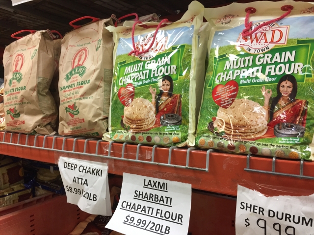 Color image of varieties of chapati flour on sale at Pooja Grocers. Photographed by Preeti Mathur in March 2017.