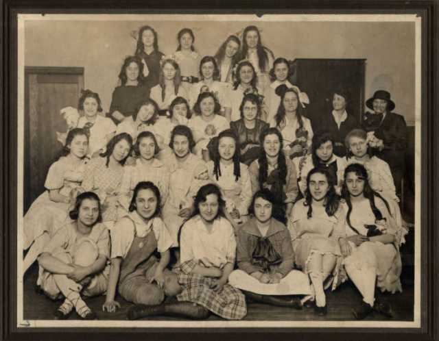 Black and white photograph of Girls’ Club doll party at West Side Neighborhood House, St. Paul, 1919.