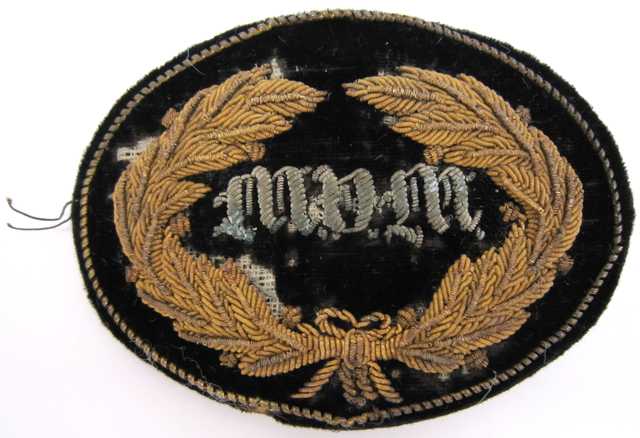 United States Army General and Staff officers hat insignia worn during the Civil War by General John B. Sanborn of the 4th Minnesota Regiment. The velvet patch is embroidered in bullion with a wreath and the letters "MVM" (Minnesota Volunteer Militia).