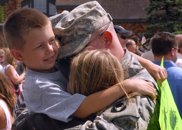 Color image of a soldier of Second Battalion, 135th Infantry, Thirty-fourth Division, returning home after a deployment, 2008.