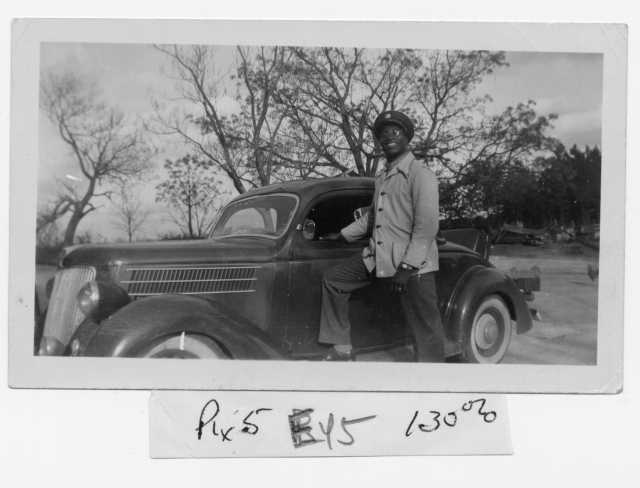 Oscar C. Howard with his first car, purchased in the 1940s while he was in college. It later served as the delivery vehicle for his catering business in Minneapolis. From the Oscar C. Howard papers (P1842), Manuscripts Collection, Minnesota Historical Society.