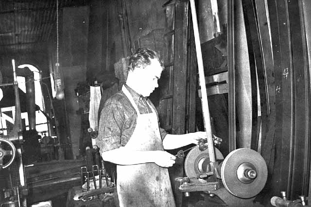 John E. Strauss, Jr. sharpening a skate blade