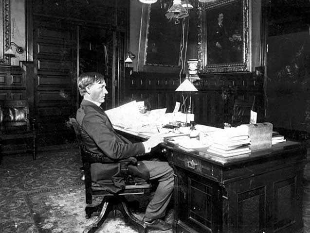 Governor John Lind seated in his office in the State Capitol